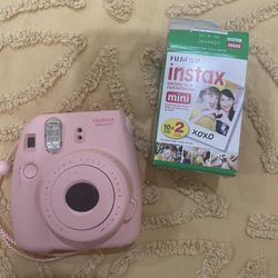 Polaroid Camera And A Set Of Film 