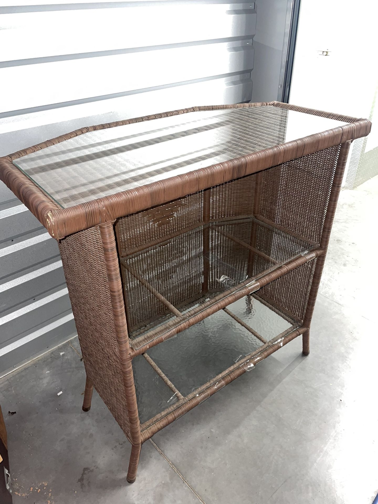 Woven stand with glass shelving