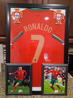 CRISTIANO RONALDO OF THE PORTUGAL SOCCER TEAM, BRANDED,AUTHENTIC FRAMED JERSEY.