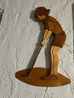 Handcrafted wooden wall art piece of a golfer putting