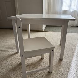 A small wooden table and chair