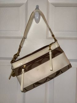 A women's shoulder bag, Featuring two credit card slots for added organization, the Nolita can and with bag charms or a different strap for a personal