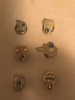 This collection features vintage Lions Clubs International award pins, primarily given for 100% attendance