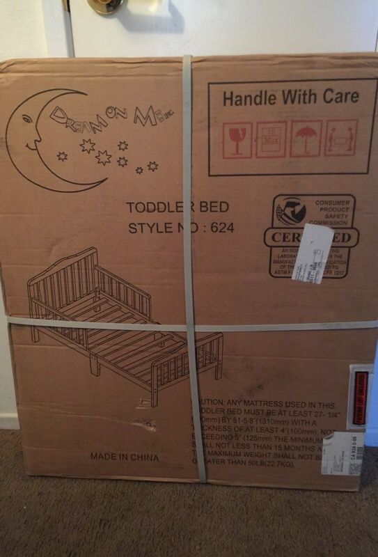 Wooden toddler bed frame includes mattress