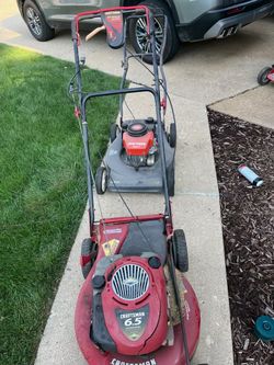 Three self-propelled lawnmowers and Billy goat vacuum