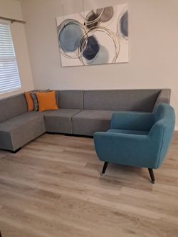 gray sofa and blue chairs