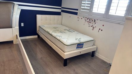 white twin bed with mattress