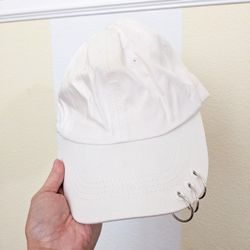 White cap with metal rings 