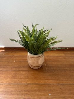 Faux fern plant in wood pot