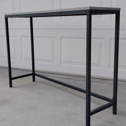 Modern  Console Table
​Sleek, minimalist design with a black metal frame and concrete-style top. In excellent, like-new condition—perfect for entryway