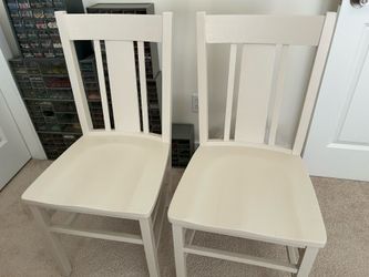 Two wooden dining chairs
