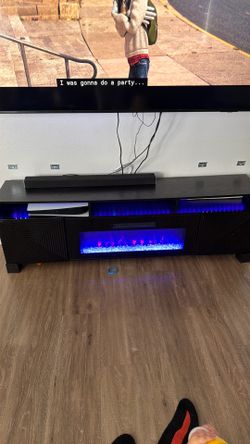 Black floating entertainment center with fireplace