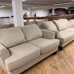 Delivery Available Beige sofa/couch + loveseat