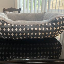 A small bed for the pet and a plastic for drinking water