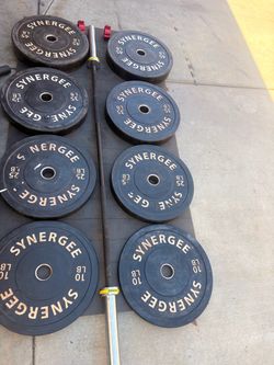Olympic rubber bumper plate set with a steel Olympic barbell. Collars and squat rack