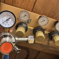 Homebrew/Kegged Beverage CO2 tank, primary regulator, and triple tap secondary regulator.