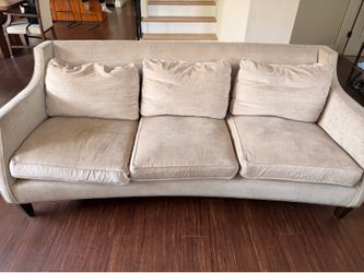 Beige sofa with nailhead trim