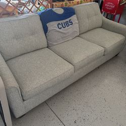 Sage green couch with a queen size pullout and three opl