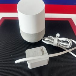 Google Home (1st Gen) smart speaker with its original power adapter.w