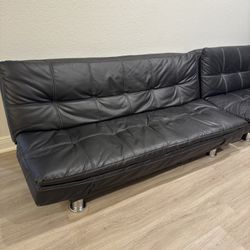 Two black leather Futons