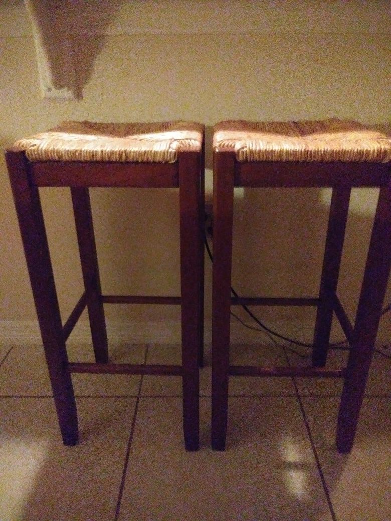 2 Bar stools with wood lags , tight women wicker top Very Sturdy . Barely used