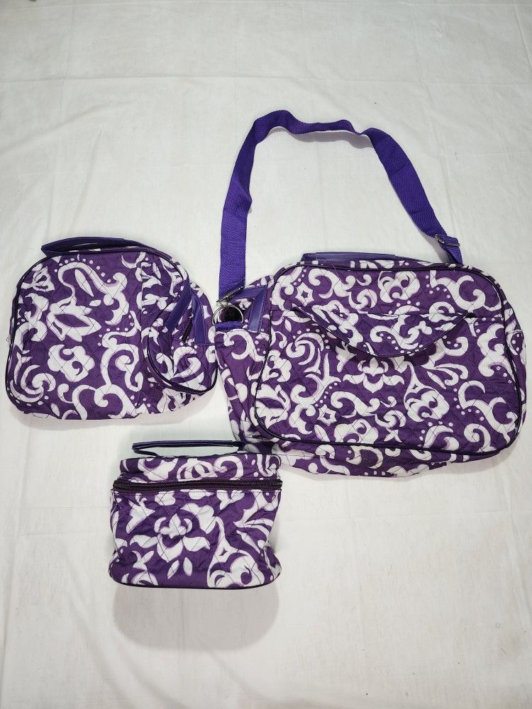 quilted purple and white damask-patterned travel bag set.