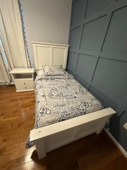 white wooden twin platform bed with panel headboard and footboard, mattress and spring box