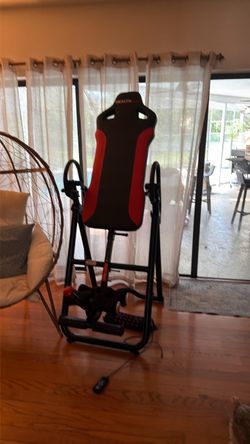 Inversion table with heated back pad