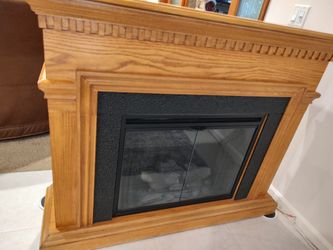 ELECTRIC FIREPLACE WITH FAUX FLAME AND BLACK METAL SURROUND