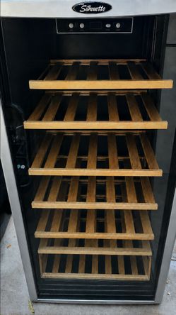 Danby Silhouette wine fridge - fits 60+ bottles. Good working condition - degree control, light, wooden shelves