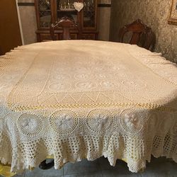 Hand crochet tablecloth in a cream color.  Scalloped hemline.  Measures 102”x62”.  Vintage without any tears.