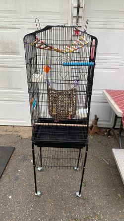 Birdcage on wheels, approximately 5 1/2 feet tall