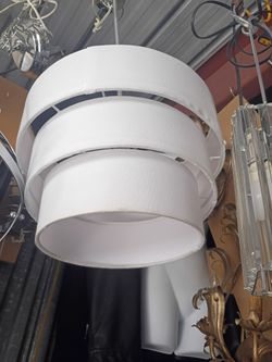 Contemporary three shade light fixt ure on a chrome ceiling mount arm it a pendant ceiling mount lightpendantceiling mount rod