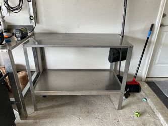 Stainless steel table with bottom storage shelf