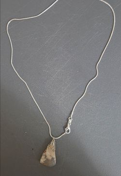 a vintage-style gemstone pendant necklace crafted from a slab of patterned natural mineral.