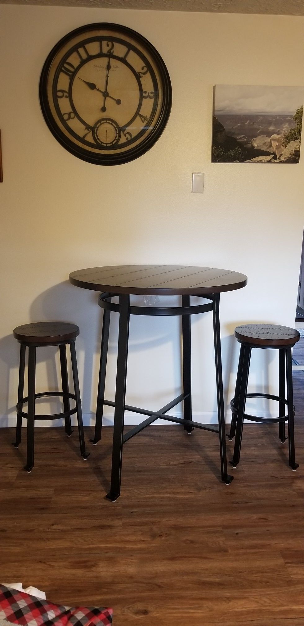 Small kitchen table with stools.