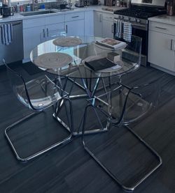 Round glass table set with 4 clear chairs