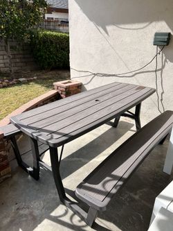 Bench with table in brown. 