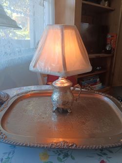 Silver serving tray and tea pot lamp.