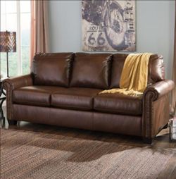 Faux brown leather pull out couch
