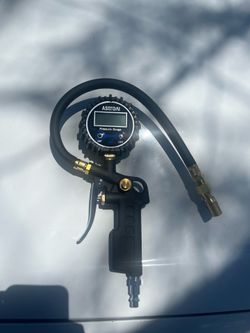 Tire inflator with pressure gauge