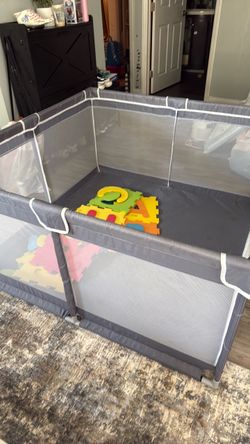 Gray Playpen assembled with foam mats