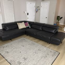 Black Leather Sectional Sofa. 