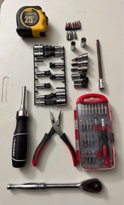 Mix of tools, husky, Milwaukee. Ratchet, pliers, bits, tape measure.