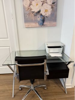 Sleek modern glass desk with genuine leather chair