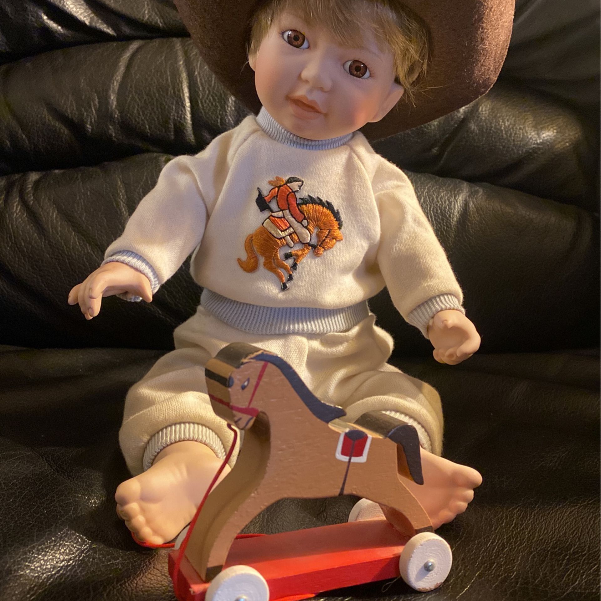 Porcelain Cowboy Baby Doll with hat & toy horse on wheels. Neck Signed B/O