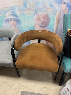 brown suede-like upholstery with a distinctive curved barrel