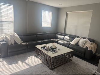 Grey couches, coffe table and grey stand