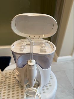 Waterpik Ultra Plus Countertop Water Flosser + Unopened Travel Flosser Combo