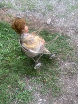 Antique doll with old stroller
